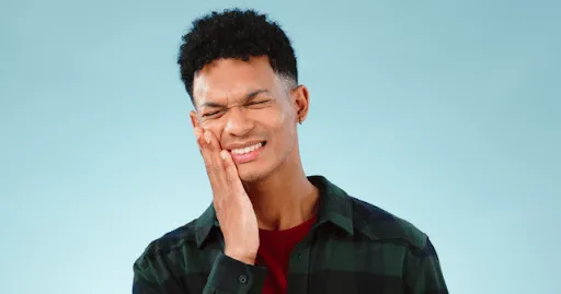 Dentist reviewing a custom night guard used to treat teeth grinding