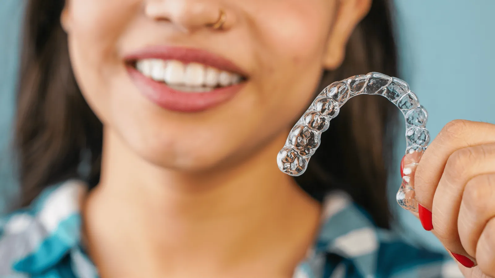 Adult patient smiling confidently after invisible braces treatment