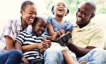 Happy smiling family relaxing together on a couch