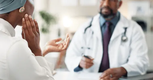 Woman holding her jaw in discomfort due to TMJ pain