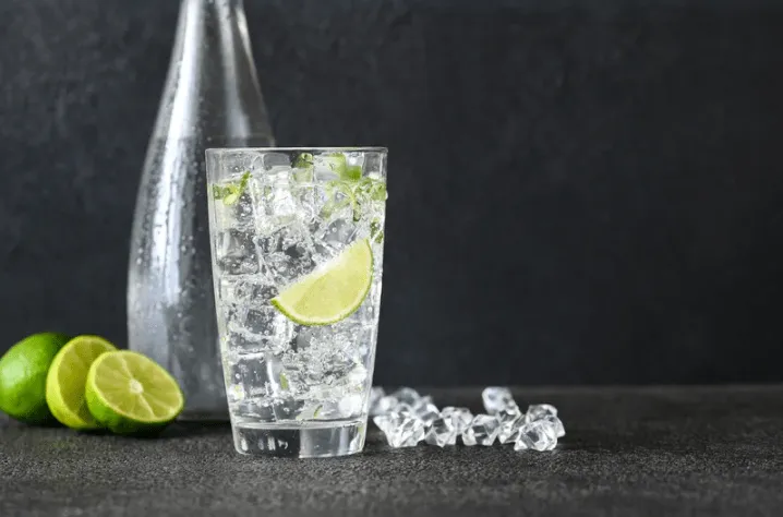 Glass of sparkling water, related to its effect on tooth enamel