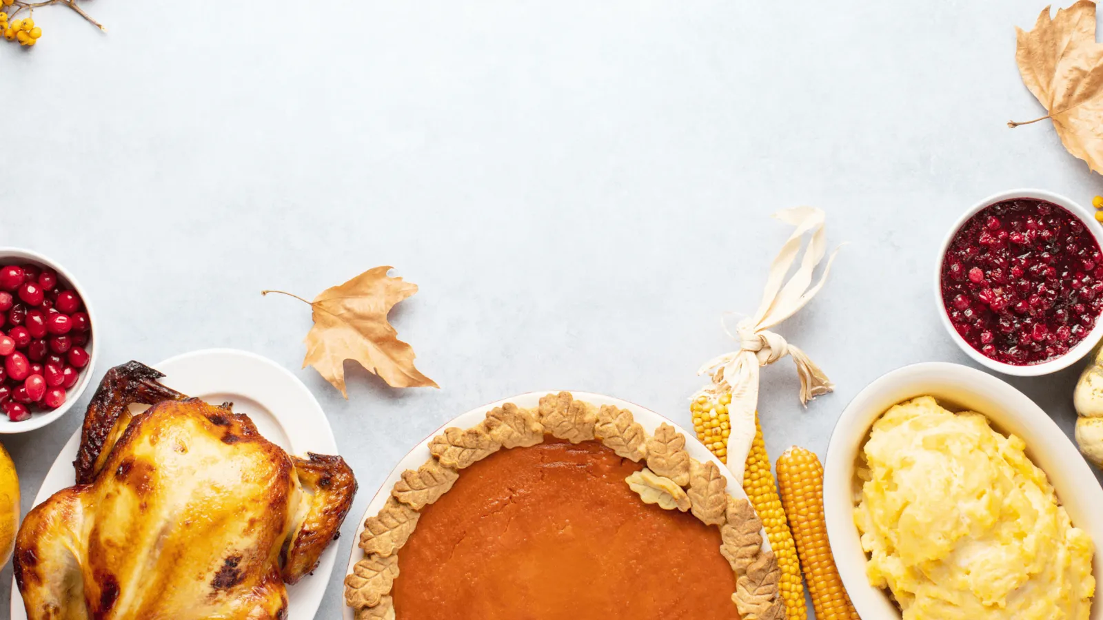 Thanksgiving dinner table spread with turkey and holiday side dishes