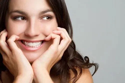 Patient smiling after dental implant treatment for a broken tooth