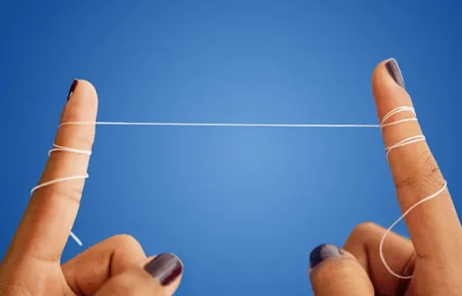Close-up of a person flossing their teeth